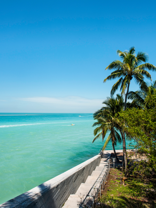 Lower Keys vacation rentals with turquoise water, palm trees, waterfront homes, docks, and quiet island scenery