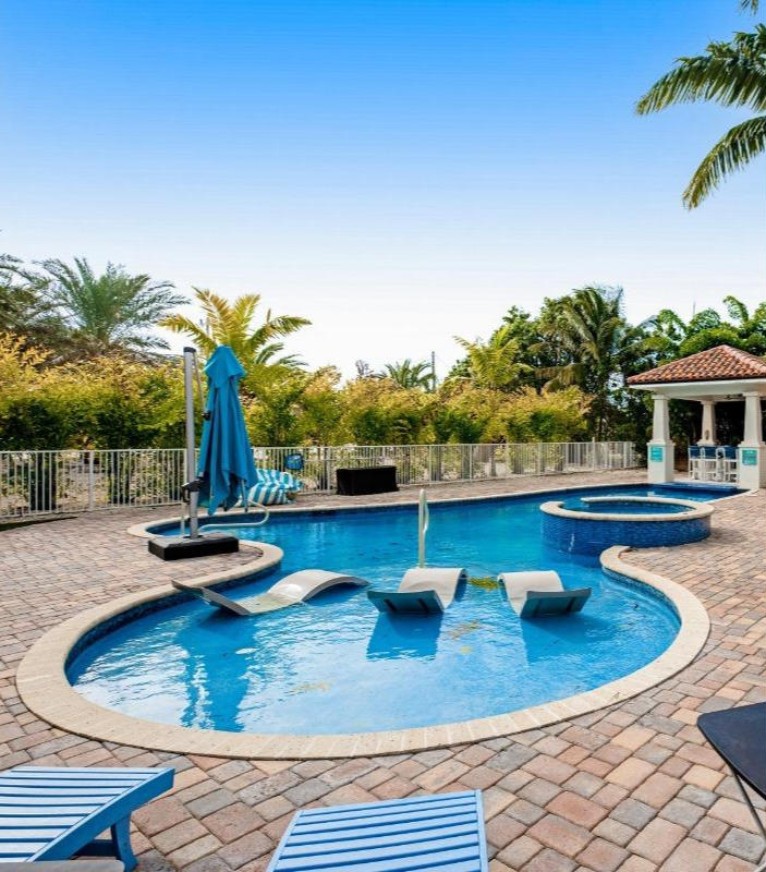 Florida Keys vacation home with a private pool, tropical landscaping, and outdoor lounge space